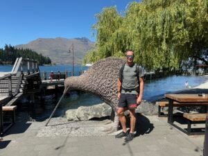 In Queenstown next to a giant kiwi bird statue